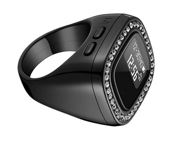 A black digital ring watch with a bezel encrusted with clear rhinestones, shown on a plain white background with a BIN ZAHID MAQET brand logo in the top-left corner.